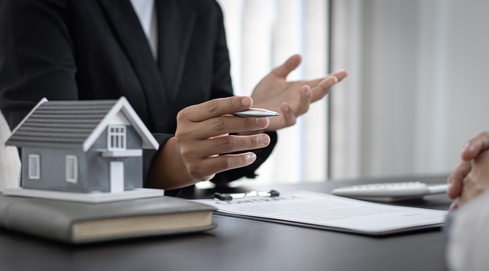 Real Estate Agent Showing Contract to Client